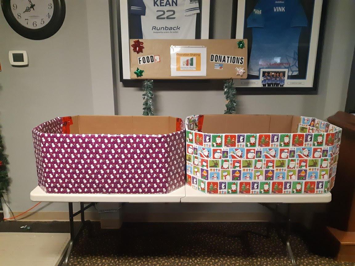 a table in the main lounge of the curling centre with christmas boxes on it
